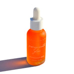 Pomegranate Glow Natural Skin Protecting Serum bottle with dropper on a clean white background