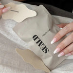 SEALD mouth tape packaging with hands holding it on a light fabric background