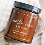 Jar of Pretty Farm Girl vanilla bean body butter on a textured surface