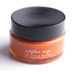 Pretty Farm Girl Wildflower Honey Lip & Face Polish jar with black lid on a white background.