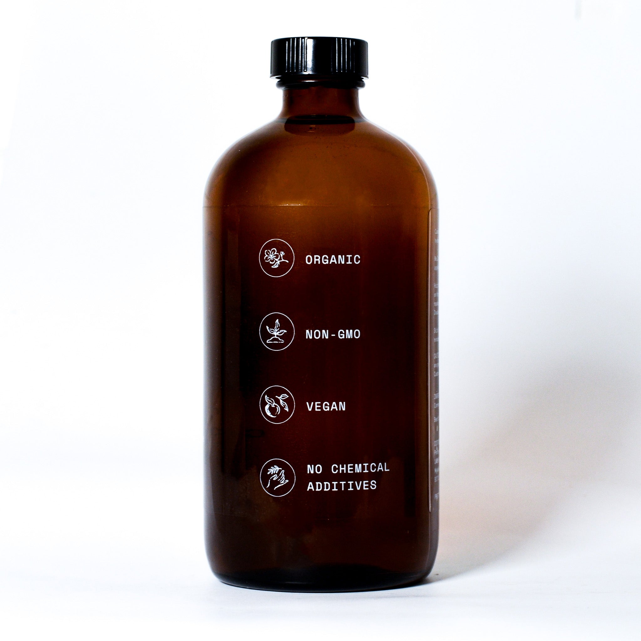 Side of amber bottle of Organic Castor Oil with benefits : Organic, NON-GMO, Vegan and without chemical additives