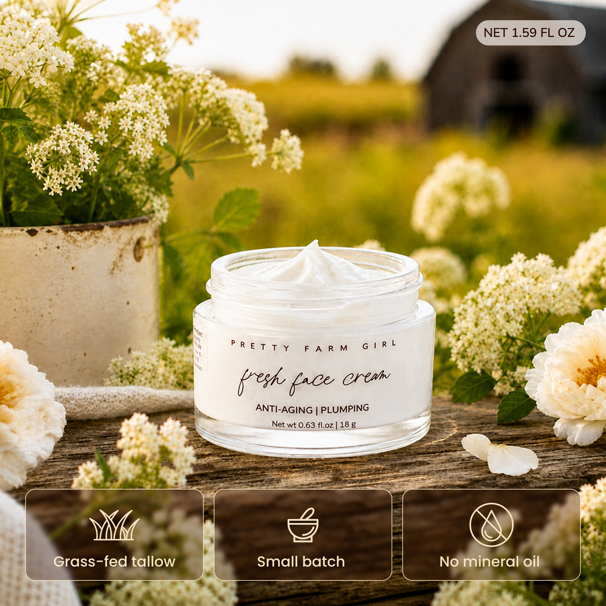 A jar of Pretty Farm Girl Fresh Face Cream is displayed on a rustic wooden surface surrounded by white wildflowers in an outdoor garden setting. Three feature badges at the bottom highlight 'Grass-fed tallow', 'Small batch', and 'No mineral oil'. 