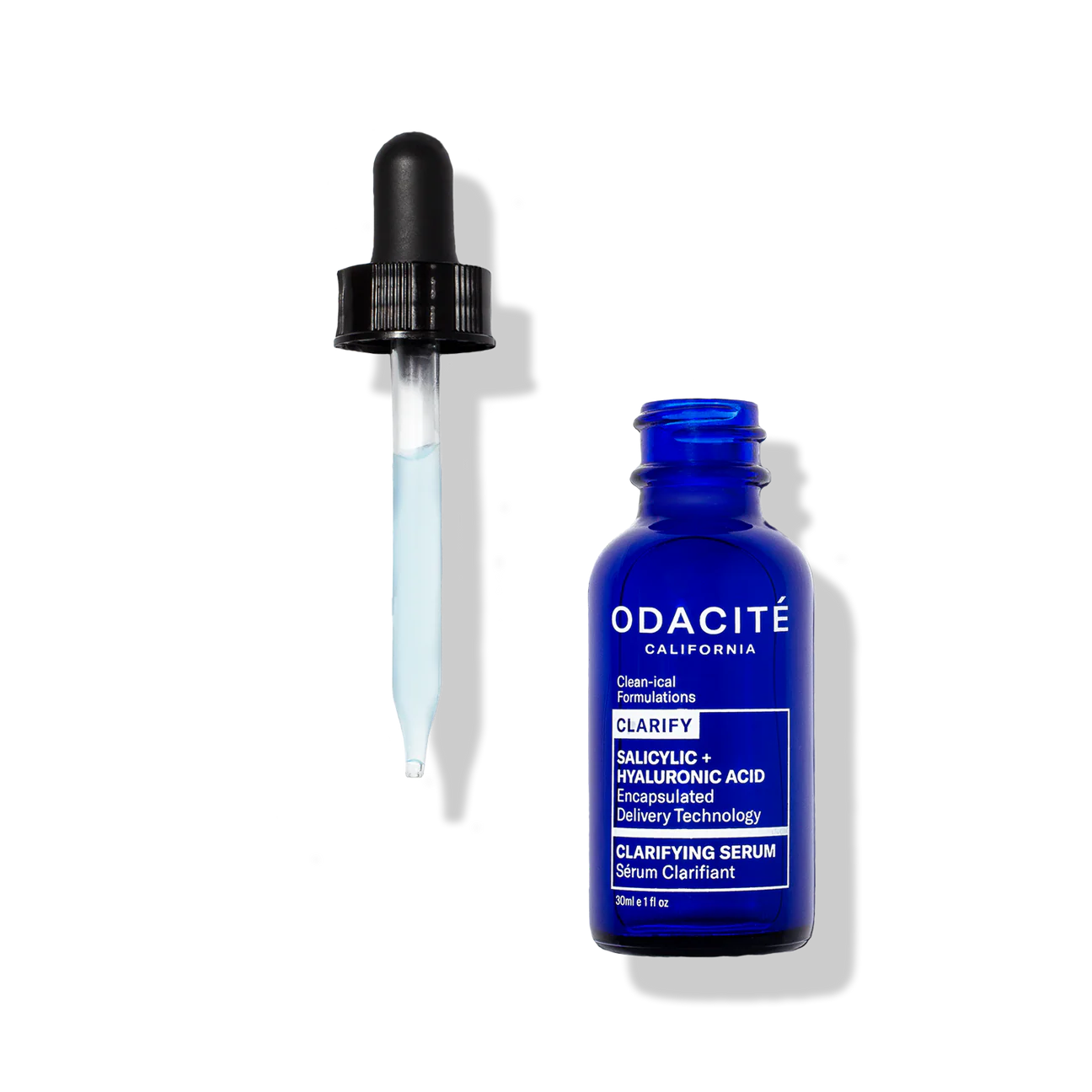 Blue serum bottle with dropper labeled 'Odacite Clarify Salicylic Hyaluronic Acid Clarifying Serum' on a white background