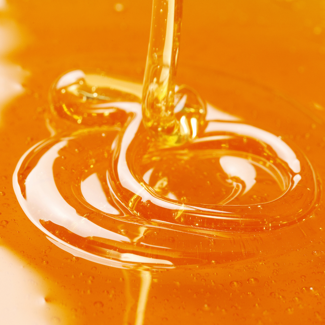 Close-up of honey being drizzled with a blurred background