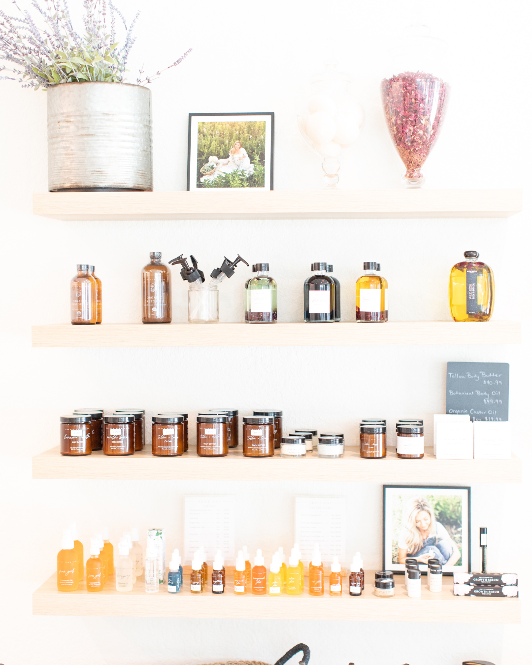 Picture of inside Pretty Farm Girl's storefront location in Sarasota, Florida displaying shelves with various bottles and jars on a white wall.