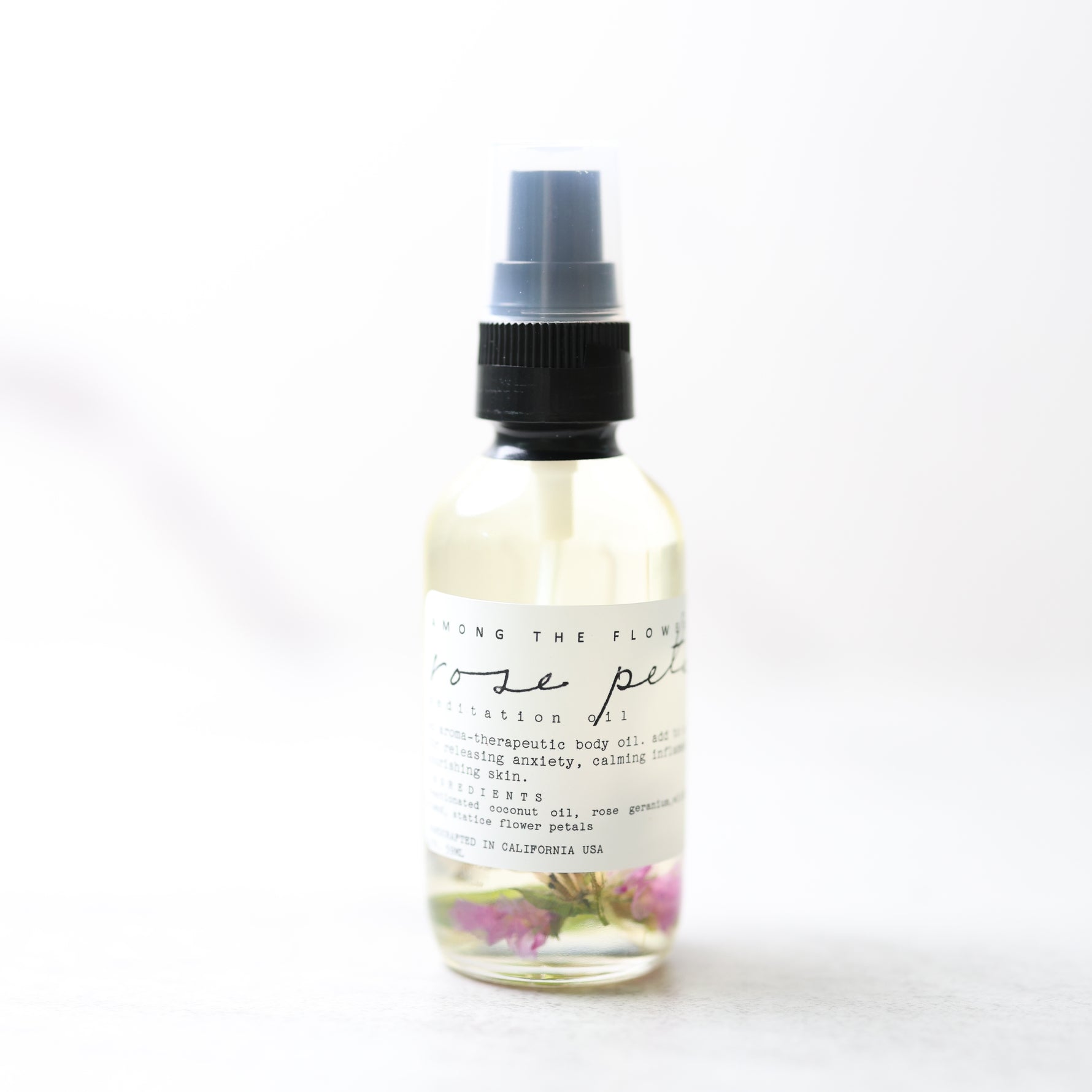 Clear bottle with a spray top on a white background