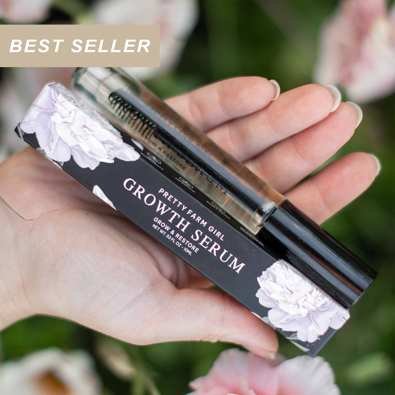 Hand holding a Pretty farm girl Growth Serum with floral background and the words best seller in the photo corner