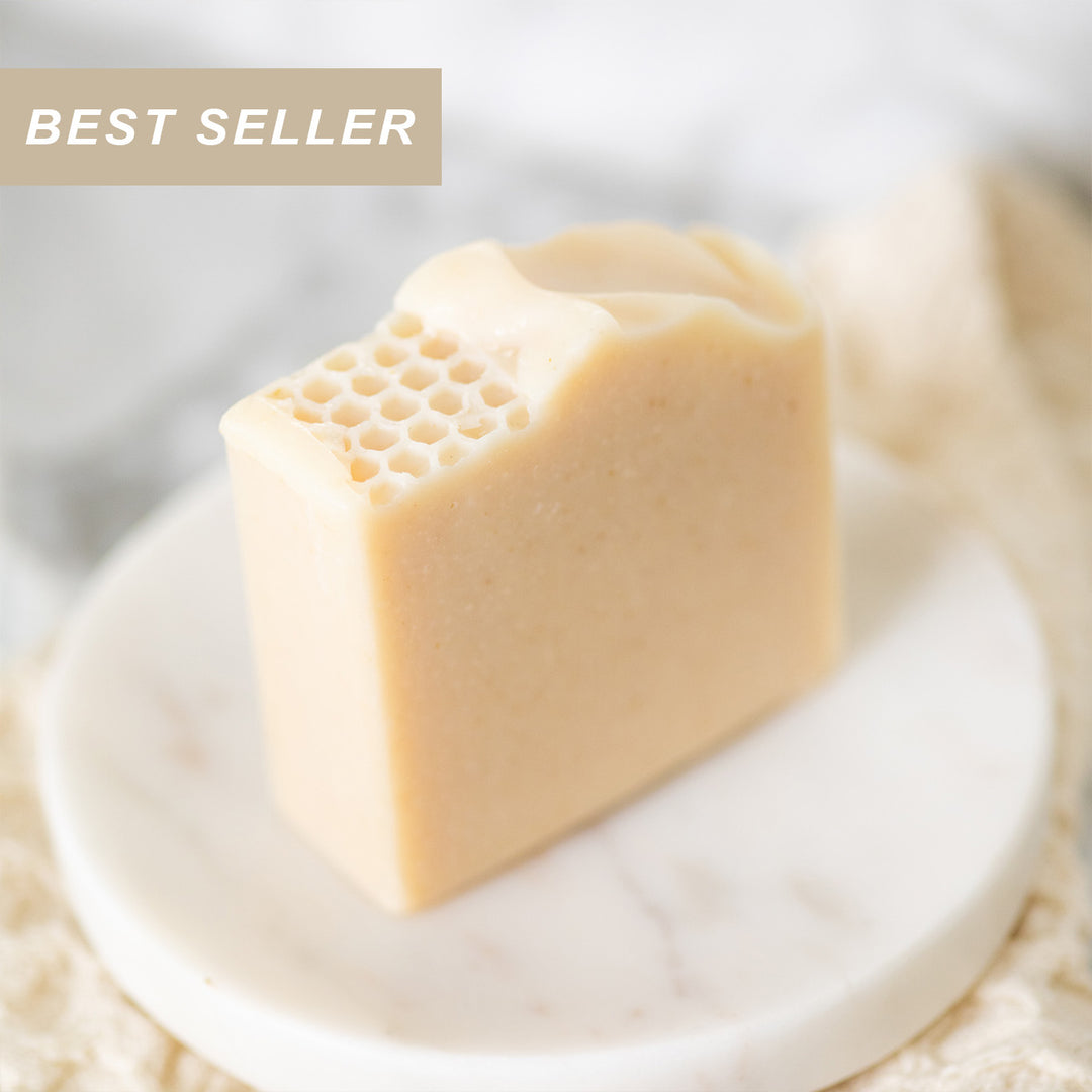 Block of soap with honeycomb texture on a white plate, labeled as a 'Best Seller'.