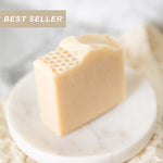 Block of soap with honeycomb texture on a white plate, labeled as a 'Best Seller'.