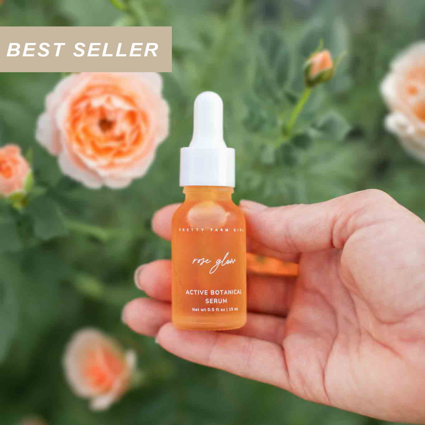 Hand holding a bottle of 'Rose Glow' active botanical serum with flowers in the background and a best seller label in the corner
