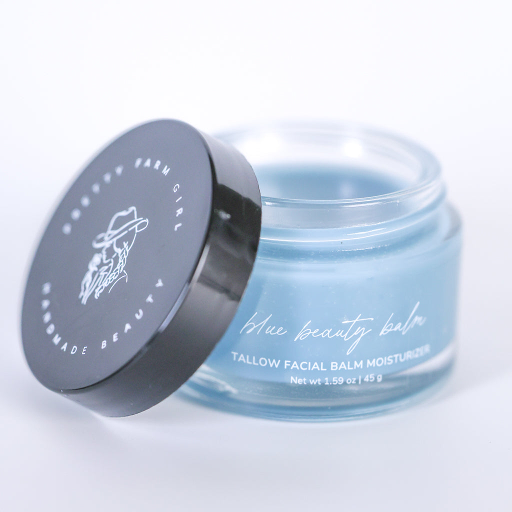 Pretty Farm Girl Blue Beauty Balm Soothing Tallow Face Balm jar with black lid on a white background.