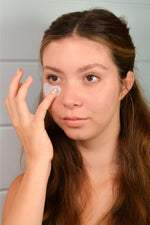 Woman applying Blue Beauty Cream tallow face moisturizer as part of her skincare routine.