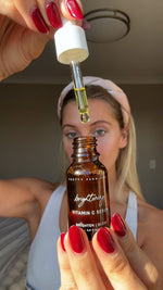 Woman holding a bottle of Pretty Farm Girl Brightening Vitamin C Serum with a dropper.