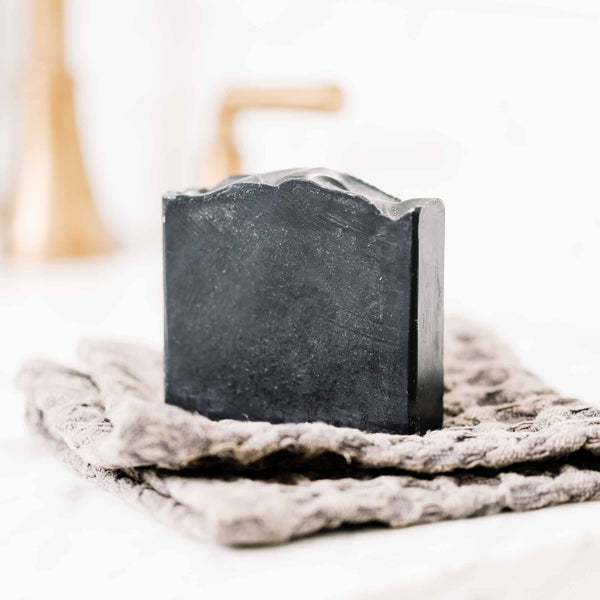 Clarifying Charcoal Bar on a soft neutral background
