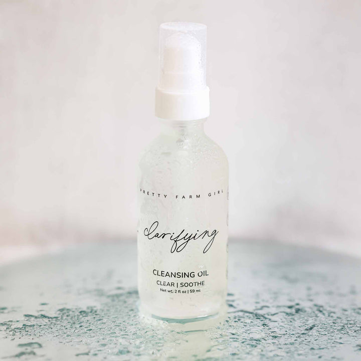 Clarifying Cleansing Oil for Acne-Prone Skin bottle displayed in a soft bathroom setting
