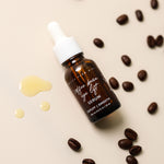 Pretty Farm Girl Coffee Bean Eye Lift Serum bottle surrounded by coffee beans and serum drops