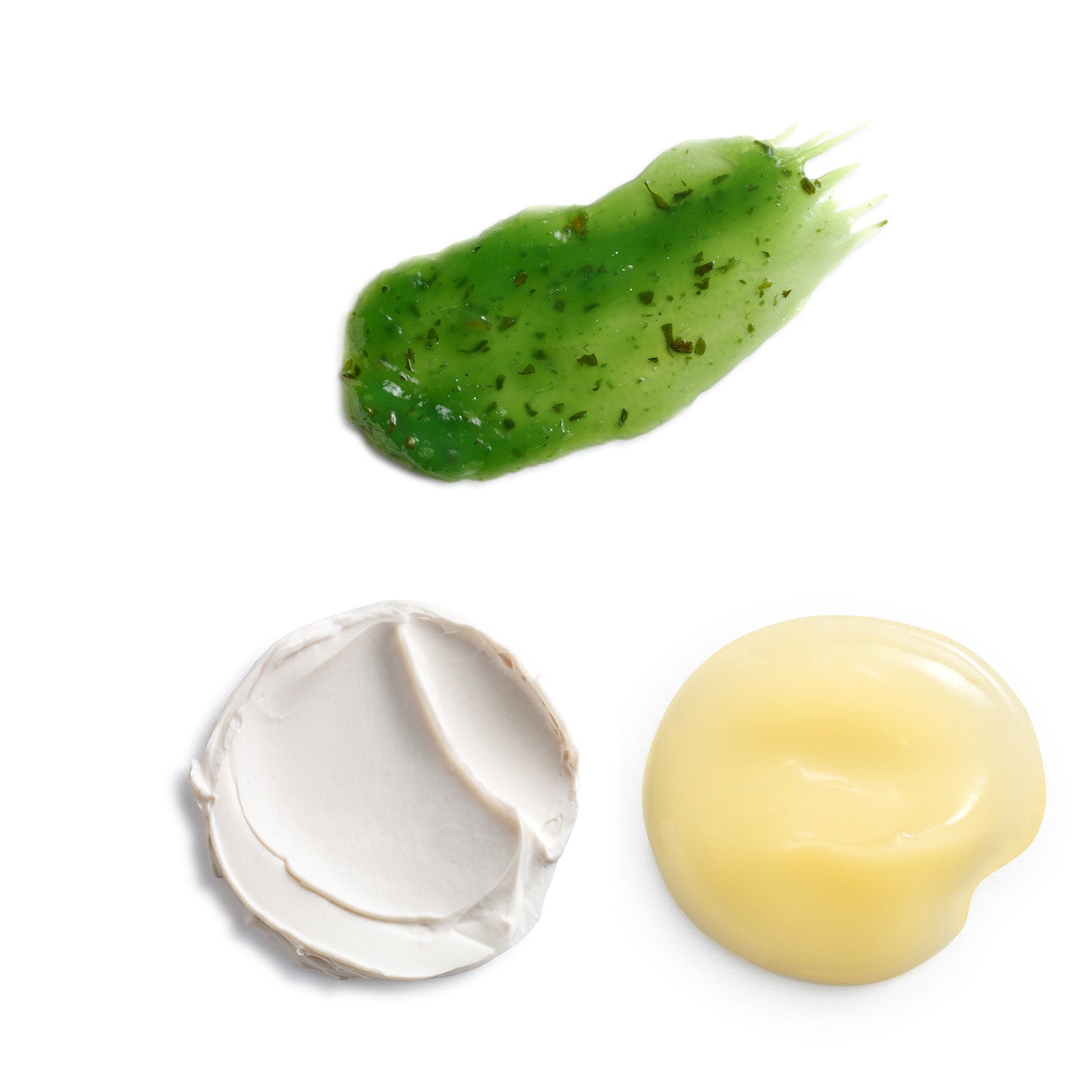 Three different textures of products on a white background. A green pesto-like masque, a white thick paste, and a yellow liquid like cream.