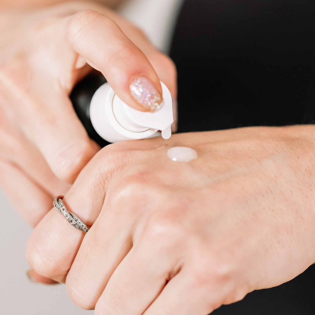 Person applying Emu Oil to their hand with a close-up view