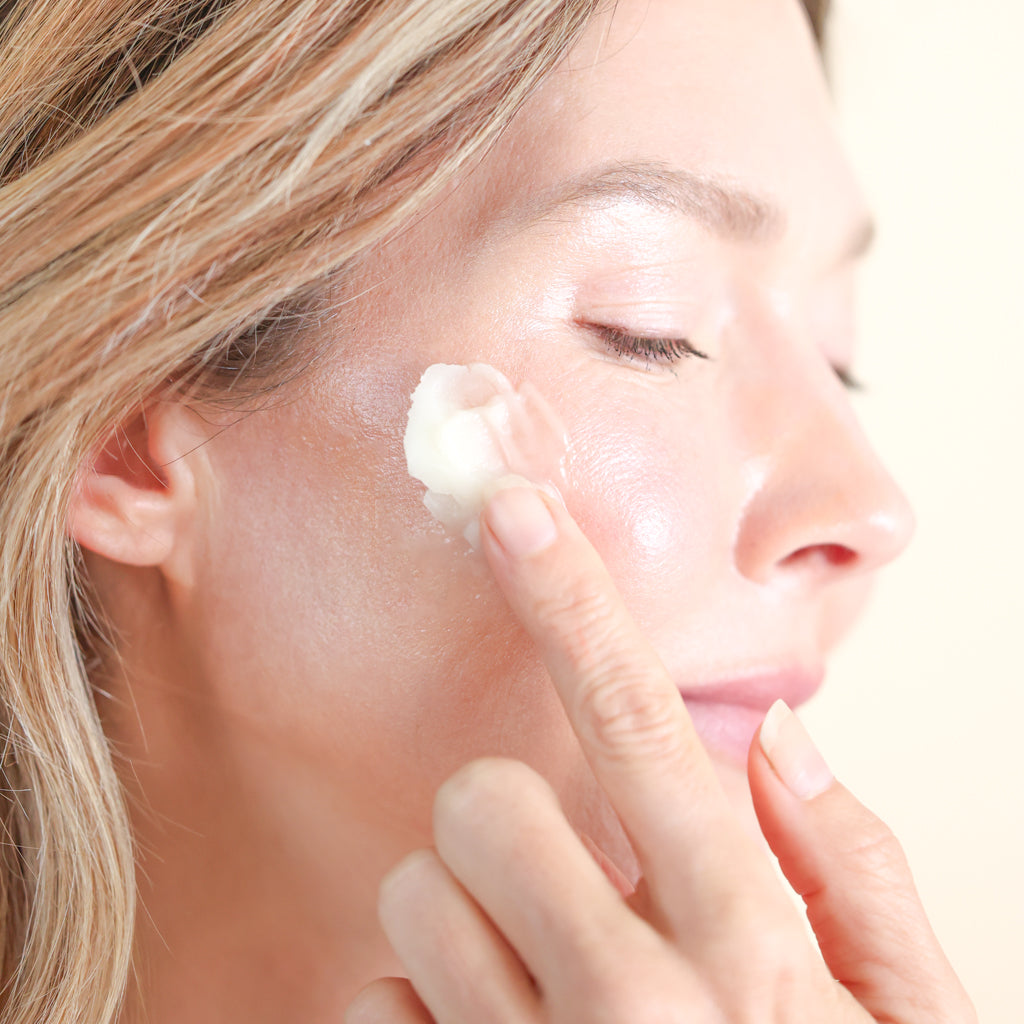 Woman applying Pretty Farm Girl Fresh Face Balm to her cheek.