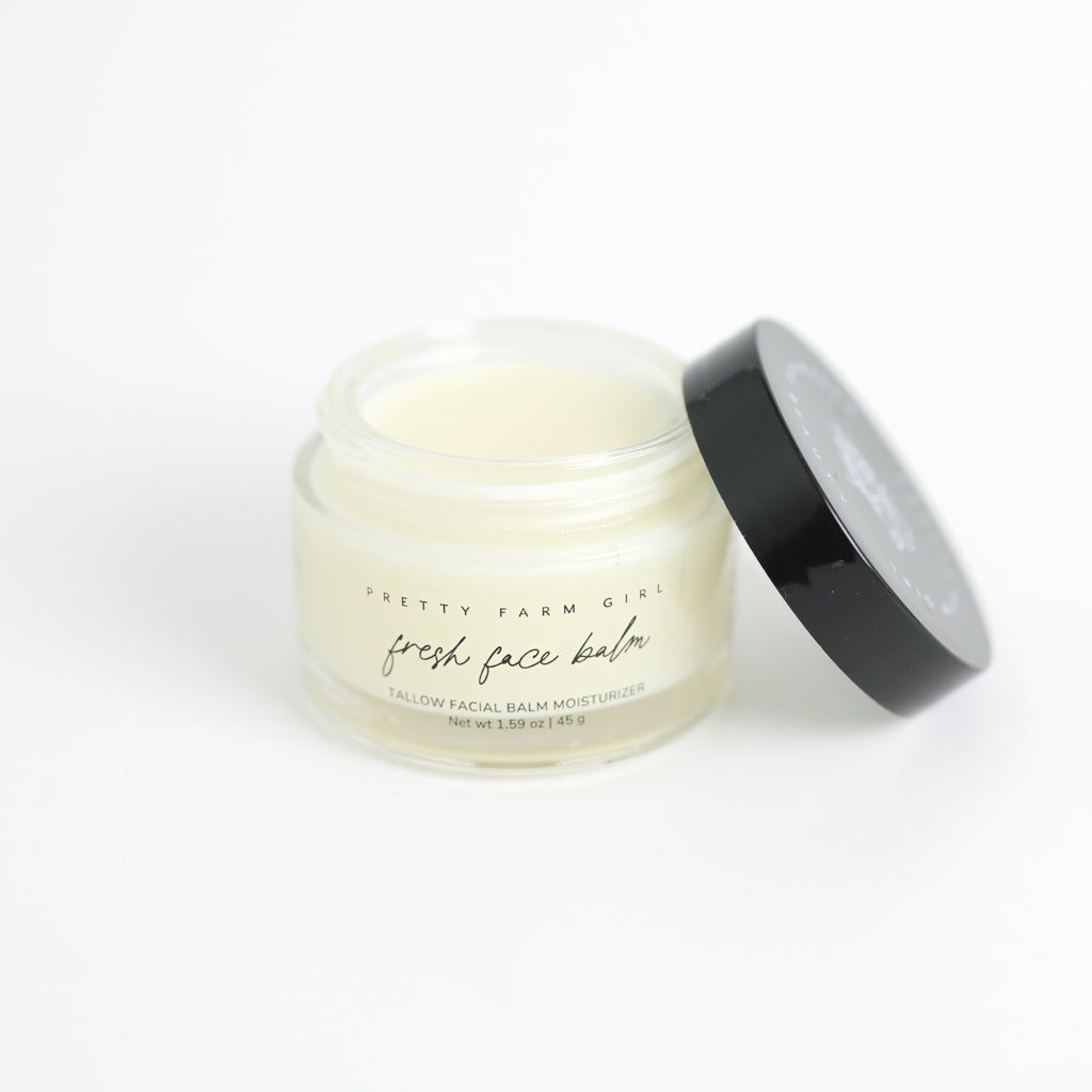 Pretty Farm Girl Fresh Face Cream jar with black lid on a white background.