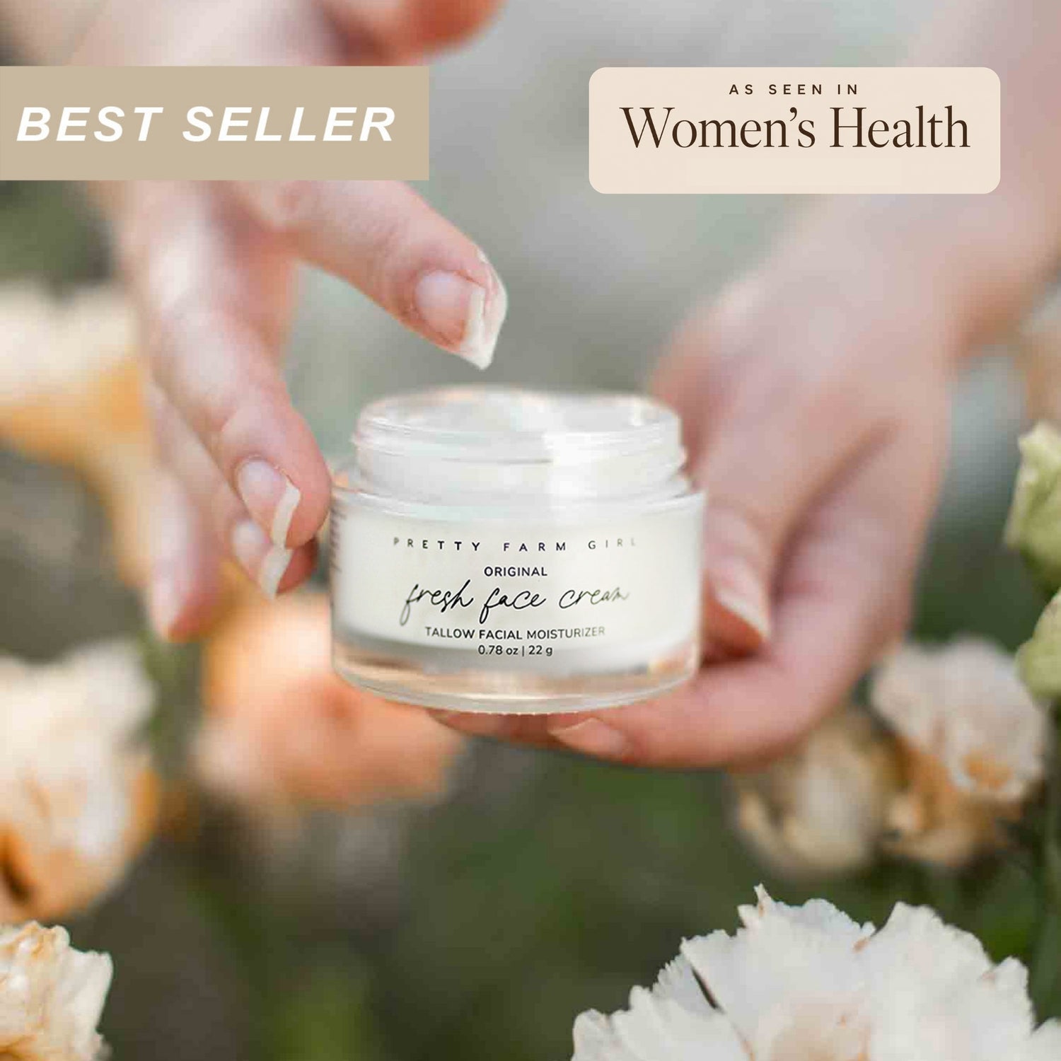 Person holding a 0.78oz glass jar of Pretty Farm Girl's beef tallow Original Fresh Face Cream with flowers in the background.