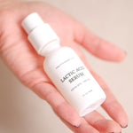 Pretty Farm Girl Lactic Acid Serum bottle held in hand with the label visible