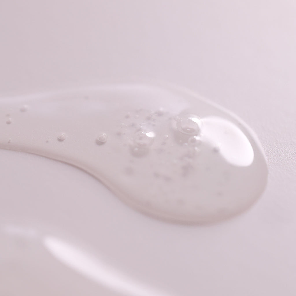Close-up of Lactic Acid Serum texture showing a lightweight gel-like formula