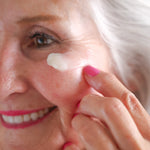 Woman applying Pretty Farm Girl Lavender Vanilla Tallow Body Balm to her cheek.