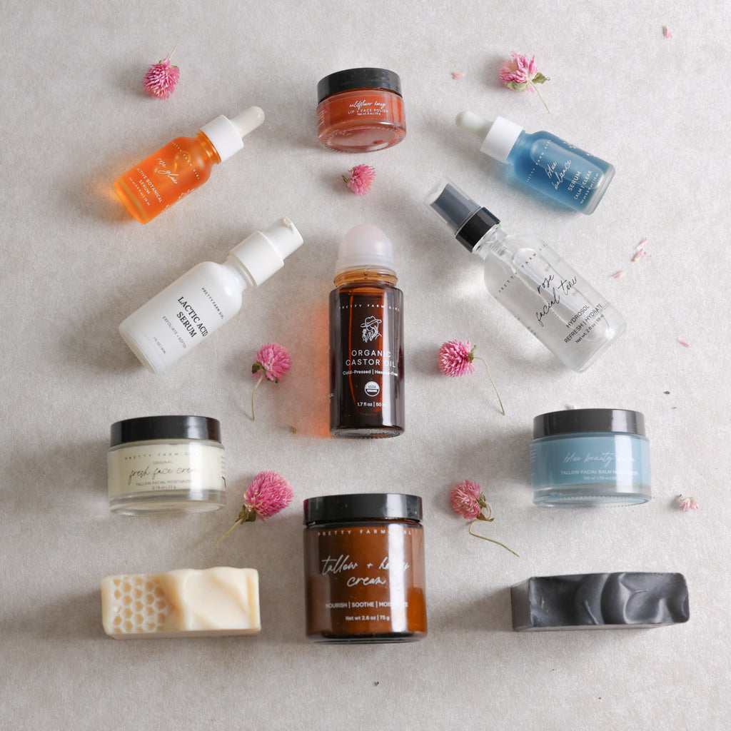 Collection of different Pretty Farm Girl products on a neutral background with flowers.
