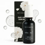 Black emu oil serum bottle with packaging featuring white flowers on a white background