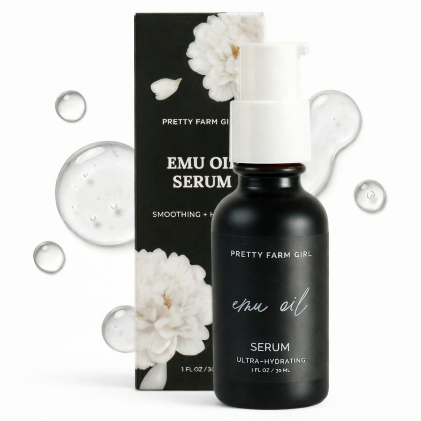 Black emu oil serum bottle with packaging featuring white flowers on a white background