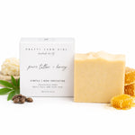 Bar of soap with packaging labeled 'Pretty Farm Girl' on a white background with honeycomb and honeycomb pieces.