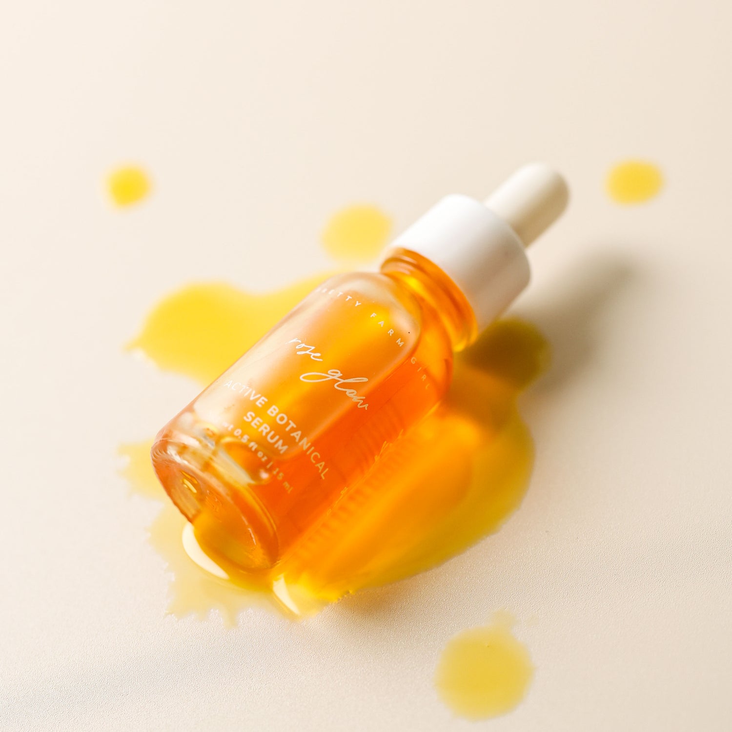 Rose Glow Active Botanical Serum bottle with golden serum texture on a soft neutral background