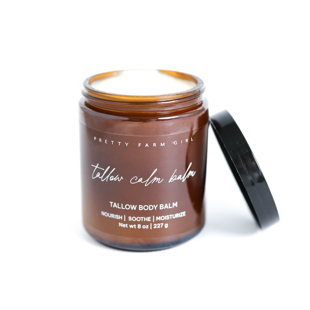 Pretty Farm Girl Tallow Calm Balm jar with black lid on a white background.