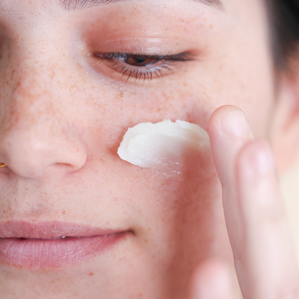 Woman applying Pretty Farm Girl "Tallow Calm Balm" to her cheek.