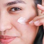 Woman applying Pretty Farm Girl Tallow + Honey Tallow Body Balm to her cheek.