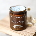 Jar of Pretty Farm Girl body butter on a wooden surface
