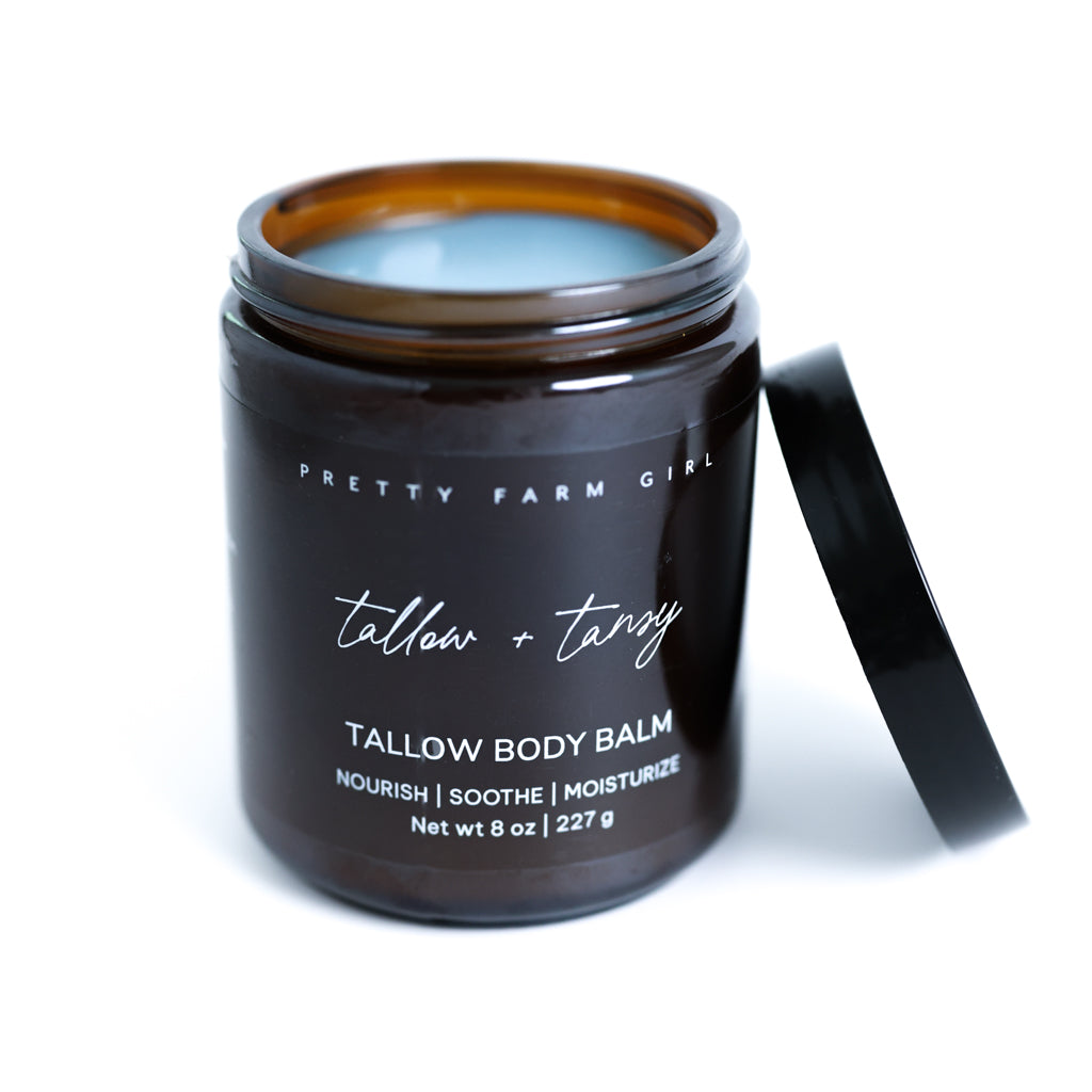 Pretty Farm Girl Tallow + Tansy Tallow Body Balm jar with black lid on a white background.