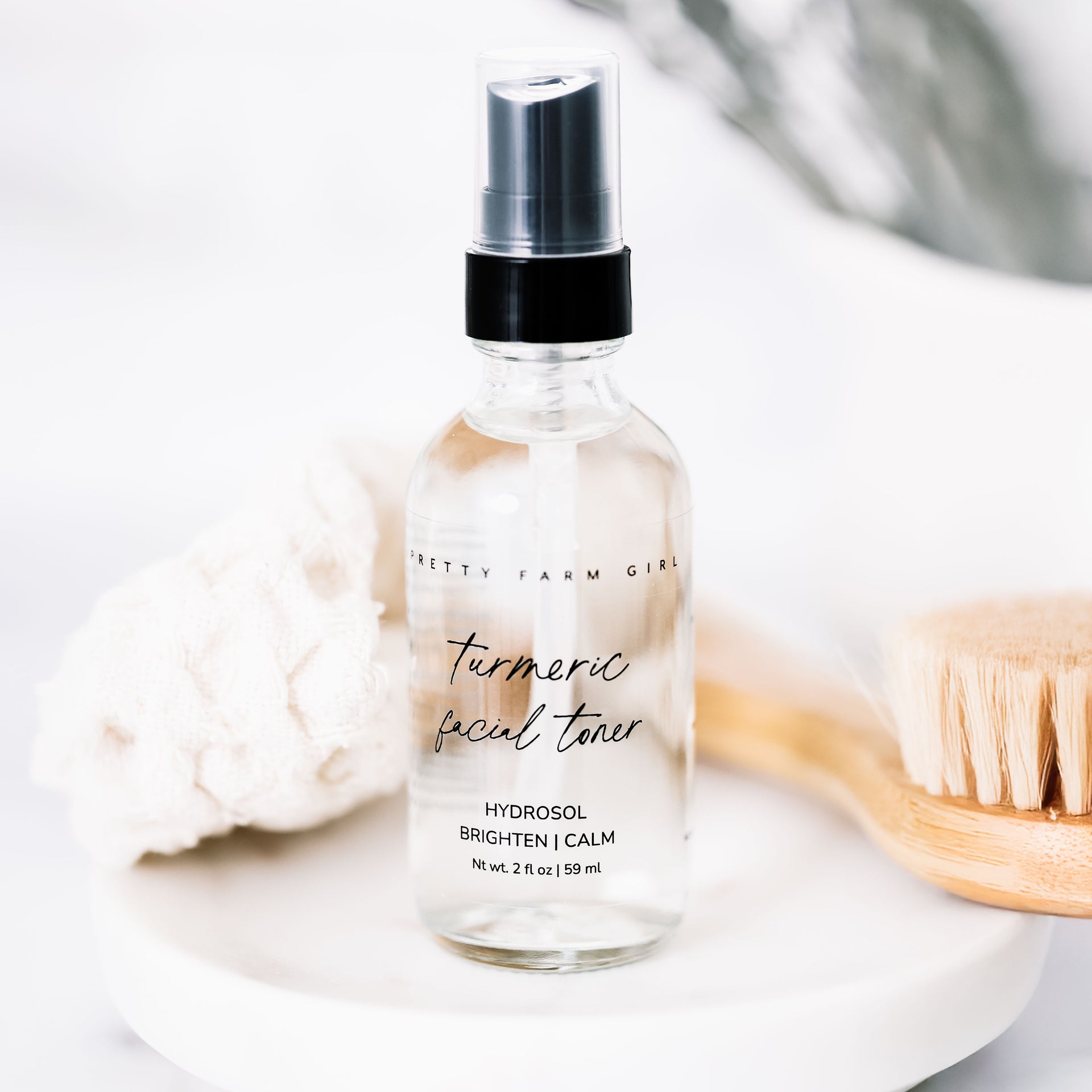 Bottle of turmeric facial toner with a black cap on a light background