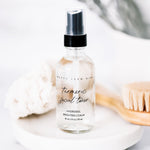 Bottle of turmeric facial toner with a black cap on a light background