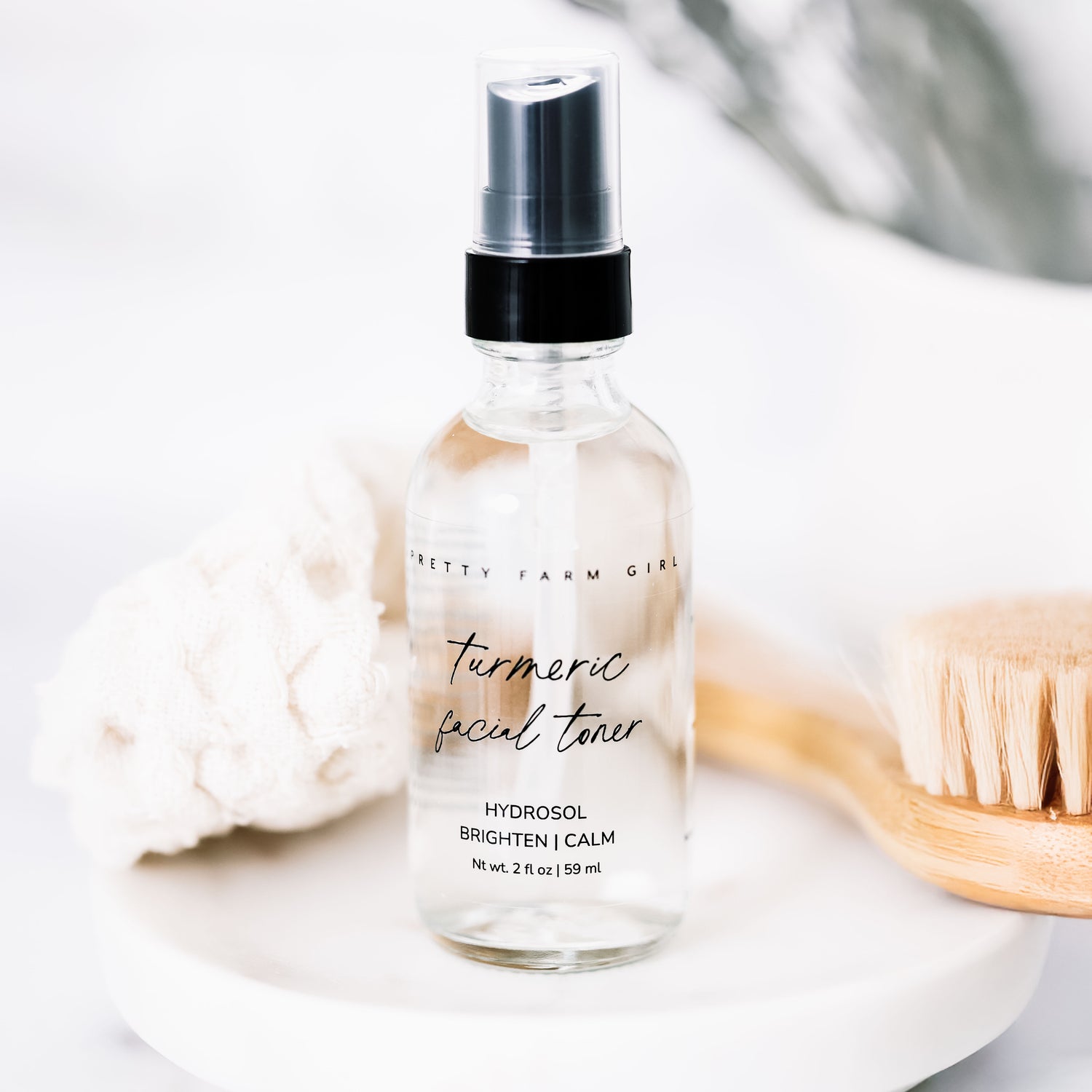 Bottle of turmeric facial toner with a black cap on a light background