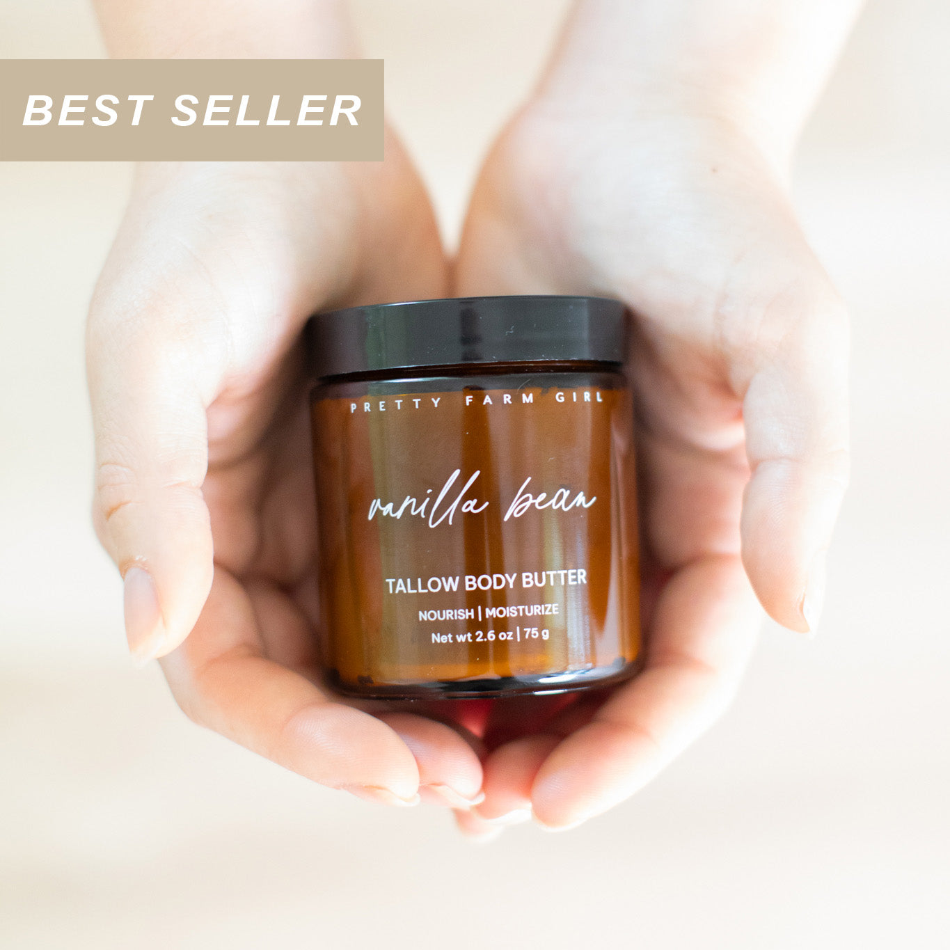 Jar of Pretty Farm Girl's 2.6oz vanilla bean beef tallow body butter held in hands with 'Best Seller' label.
