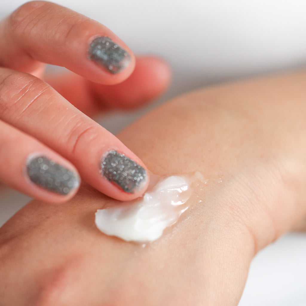 Pretty Farm Girl Vanilla Bean Tallow Body Balm being applied to the hand.