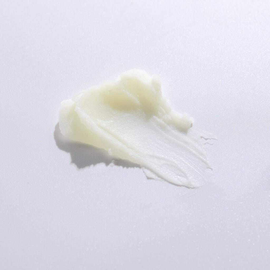 Close-up of Pretty Farm Girl Vanilla Bean Tallow Body Balm texture on a neutral background.