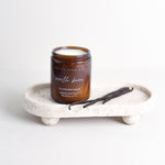 Pretty Farm Girl Vanilla Bean Tallow Body Balm jar on a white stone tray with vanilla bean accents.