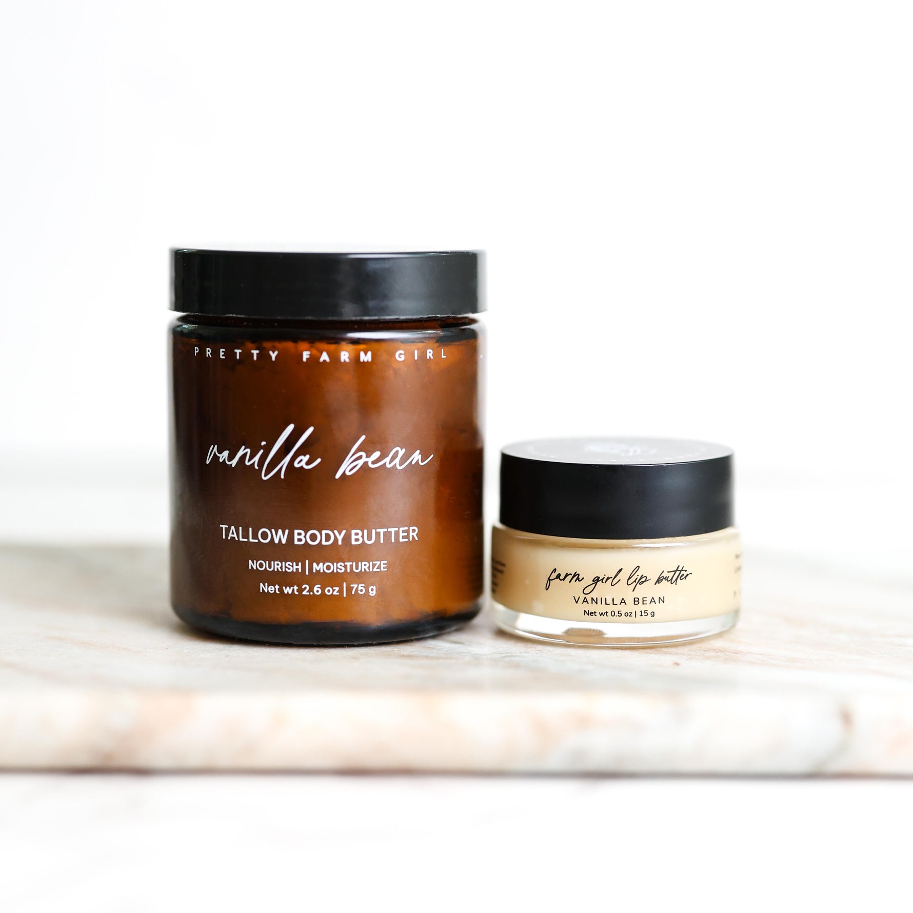 Two jars of 'Pretty Farm Girl' vanilla bean body butter and lip balm on a white surface.