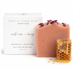 Wild Rose + Honey Handmade Tallow and Goat Milk Soap Bar with product packaging and honeycomb on a white background