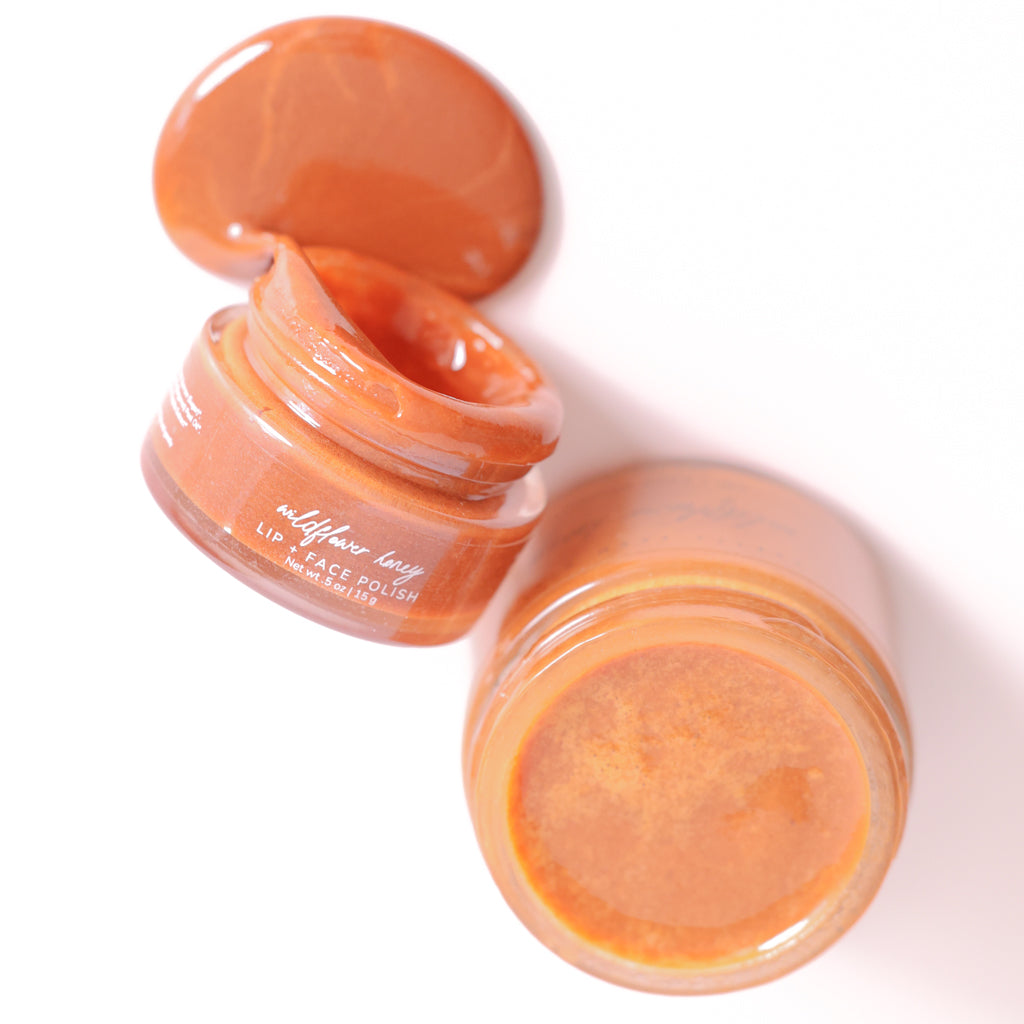 Jars of wildflower honey lip polish  showing the texture of the cream
