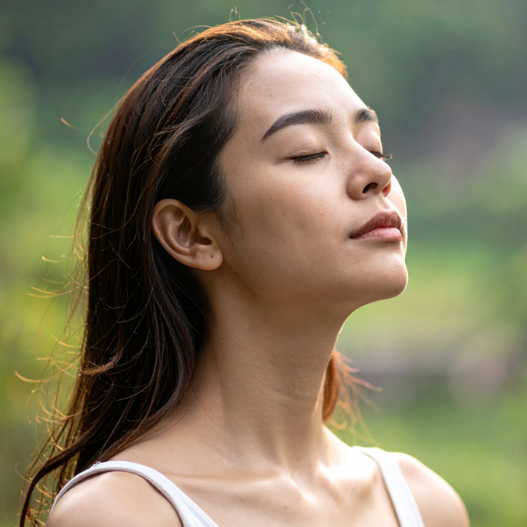 Woman with eyes closed in a natural setting