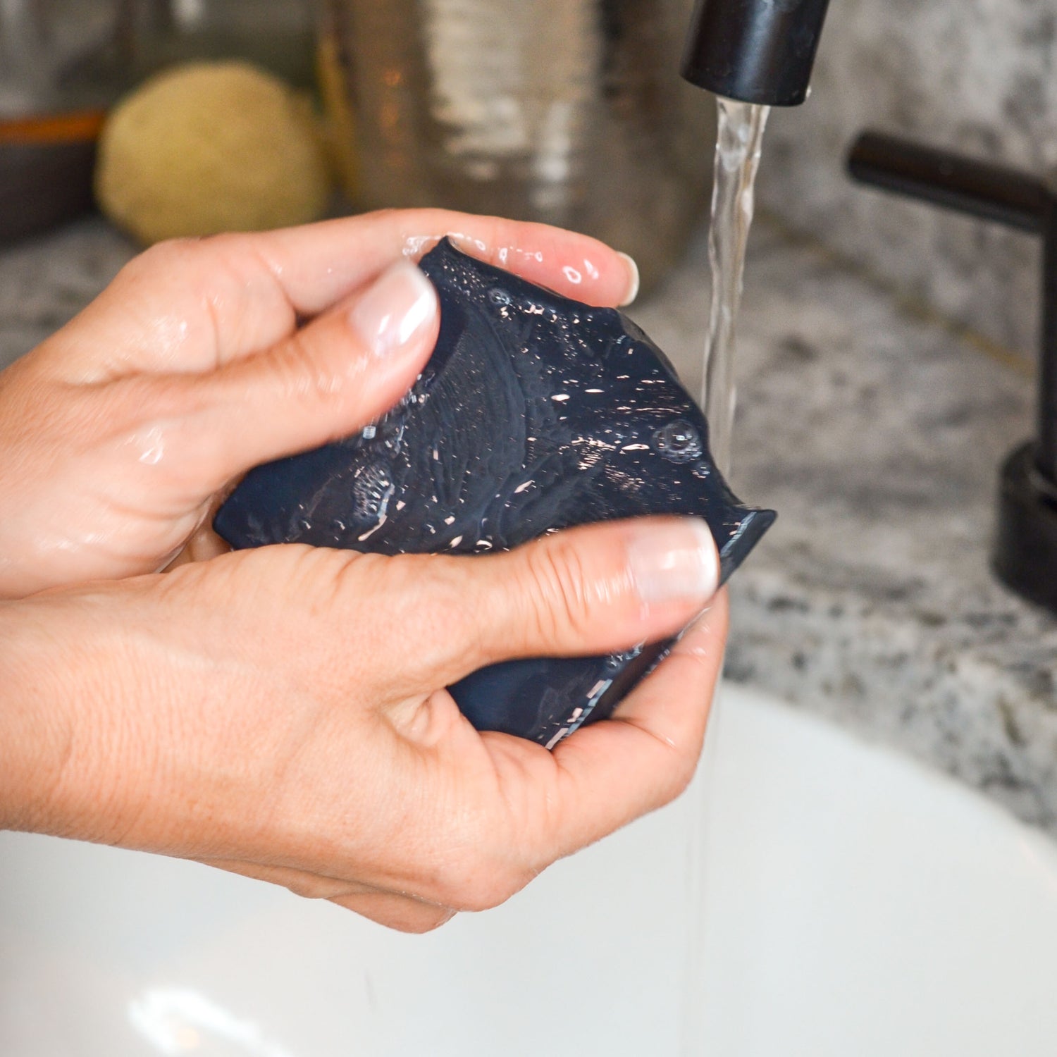 Clarifying Charcoal Bar held under running water